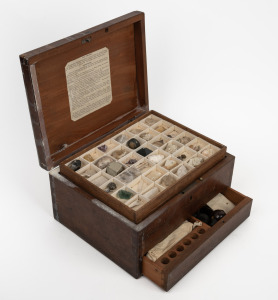 An antique mineralogical specimen box with original contents, bearing lithograph paper labels "J. Tennant, Mineralogist to Her Majesty, 149, Strand, London", the box 13cm high, 25cm wide, 20cm deep.