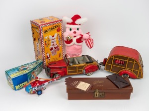 DURACELL Christmas bunny in box, clockwork rescue helicopter in box, a Chinese model car and caravan; together with an antique leather glove box, 20th century, (4 items), the car and caravan 60cm long overall.