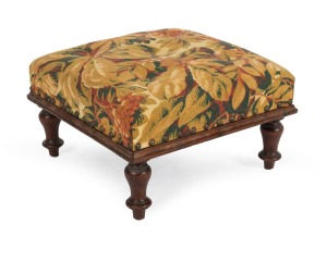 An Australian cedar footstool with floral upholstered top, New South Wales origin, circa 1855, 19cm high, 35cm wide, 35cm deep.