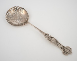 An antique English sterling silver serving spoon, beautifully pierced and decorated with floral motif, 19th century, 21cm long, 52 grams.