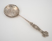 An antique English sterling silver serving spoon, beautifully pierced and decorated with floral motif, 19th century, 21cm long, 52 grams.