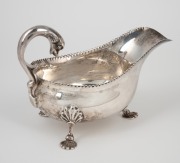 An antique Scottish sterling silver sauce boat with pad feet and dolphin handle, made by Hamilton & Inches of Edinburgh, circa 1910, ​​​​​​​11cm high, 16cm wide, 200 grams. - 2