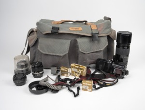 NIPPON KOGAKU: A padded bag containing many Nikon camera accessories, including three lenses, one teleconverter, one flash unit, and much else besides.
