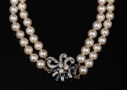 A double strand cultured pearl necklace with white gold, diamond and sapphire clasp, housed in a Hardy Brothers plush box, 55cm long. - 2