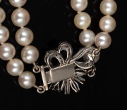 A double strand cultured pearl necklace with white gold, diamond and sapphire clasp, housed in a Hardy Brothers plush box, 55cm long. - 3