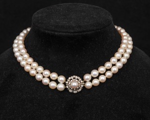 A double strand cultured pearl choker with white gold and diamond clasp, 34cm long.