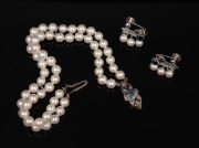 A double strand cultured pearl bracelet with 9ct white gold, diamond and blue sapphire clasp; together with a pair of 9ct white gold, pearl and sapphire earrings, 20th century.