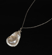 A sterling silver mounted pearl shell pendant on sterling silver chain, housed in a MIKIMOTO branded plush box, ​​​​​​ ​​​​​​​the pendant 3.5cm high, the chain 60cm long. - 2