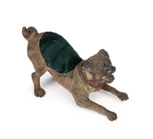 An antique Austrian cold painted bronze pug dog pin cushion, circa 1900, 7cm high, 13cm long.