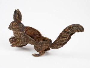 An antique Austrian cold painted bronze figural pen wipe in the form of a squirrel, circa 1900, 8cm high, 13.5cm long.