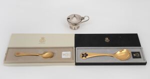 Two GEORG JENSEN Danish gilded silver and enamel spoons in original boxes, together with a sterling silver mustard pot (glass liner and base glued in), 20th century, (3 items), the spoons 70 grams total, the mustard pot 96 grams total including lining and base.