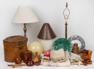 Two brass table lamps with shades, a copper lamp shade, an antique painted metal hat box, a vintage spherical glass shade, pottery jars, assorted wood ware, green majolica plate, a commemorative plate, assorted lace tablecloths and napkins, mixed vintages