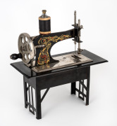 An antique German miniature sewing machine, early 20th century, ​​​​​​​21cm high.