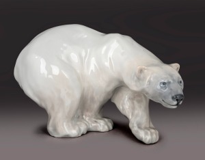 ROYAL COPENHAGEN porcelain polar bear statue, designed by Knud Kyhn, early 20th century, factory mark to base, 17cm high, 27cm long.