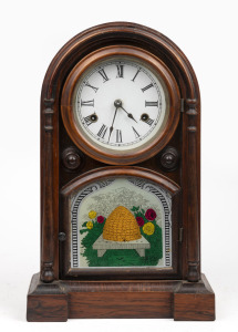 An antique American shelf clock in rosewood case with beehive decorated glass front, eight day time and strike movement with Roman numerals, 19th century, ​​​​​​​43cm high.