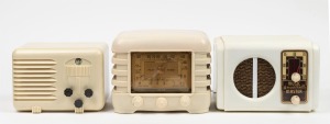 Three assorted cream and white bakelite cased mantle radios, the largest 17cm high.