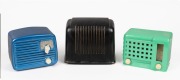 Three assorted vintage radios comprising of a SILVERTONE in blue metal case, an EMERSON in bakelite case with later green painted finish, and a brown bakelite example, ​​​​​​​the largest 16cm high.