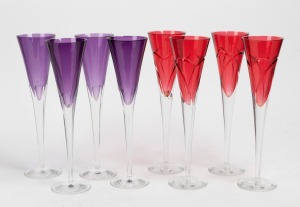 WATERFORD champagne flutes, two sets of four in ruby and purple cut crystal, (8 items), each piece with acid etched factory mark to base "Waterford", approximately 28cm high.