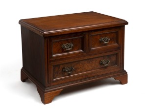 An antique walnut three drawer miniature chest, (later added feet),19th/20th century, ​​​​​​​31cm high, 42cm wide, 31cm deep.