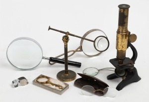 Antique microscope, scientific table magnifier, antique pince-nez in case, jewellers loop and assorted magnifying glasses, 19th and 20th century, the microscope 25cm high.