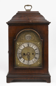 An antique English two train spring table clock with eight day bell striking movement, break arch brass dial with tempus fugit plaque to the arch. The movement housed in a custom made walnut veneered case, early 20th century. 53cm high.