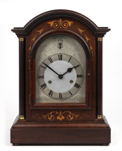 H. A. C. WURTTEMBERG antique German mahogany cased mantle clock with floral boxwood inlay and capitals. One piece arched silvered dial with strike silent subsidiary and Roman numerals. Eight day spring driven quarter gong striking movement, circa 1900. ​​