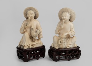 A pair of Chinese carved ivory seated figures on carved wooden bases, early to mid 20th century, 12.5cm high overall including stands.