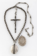 Antique silver crucifix on silver fob chain, together with two antique silver lockets, one on a silver chain, 19th/20th century,