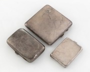 Two antique sterling silver cigarette cases, together with a sterling silver vesta case, (3 items), ​​​​​​​the largest 8cm wide, 186 grams total.