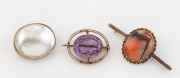 Three antique 9ct gold brooches, set with pearl shell, agate and purple stone, 19th/20th century, the largest 5.2cm wide, 22.8 grams total (including stones).