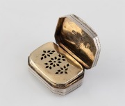 An antique sterling silver vinaigrette with engraved decoration and gilt wash interior and grill (note: grill hinge loose), made in Birmingham, circa 1807, 2.4cm wide. - 2