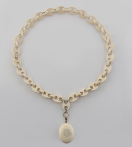 An antique carved ivory locket on an impressive carved ivory link chain, 19th century, the locket 4.5cm high, the chain 60cm long.