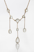 An antique 9ct rose gold negligee necklace, set with white stones, early 20th century, the chain 40cm long, the centre pendant drop 5.5cm high, 7 grams total.