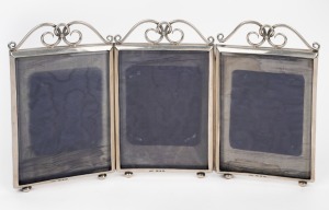 An antique English sterling silver three-fold picture frame, made in Birmingham, circa 1897, 18cm high, 32.5cm wide.