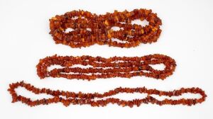 Three assorted amber bead necklaces, 20th century, ​​​​​​​the largest 165cm long.