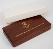 SYDNEY 2000 OLYMPIC GOLD COIN COLLECTION: PM/RAM collaborative issue set of eight coloured $100 gold proofs, 79.998g pure gold, in jarrah presentation case with box and CoA. - 2