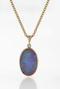 A 9ct gold mounted opal doublet pendant on gold chain, 20th century, the chain 50cm long.