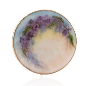 An Australian 9ct rose gold mounted brooch with hand-painted floral porcelain panel, signed verso "Y. WOOD", early 20th century, 4cm diameter.