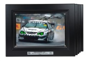 CRAIG LOWNDES - 2001: Ten identical framed and glazed signed photographs of Lowndes in his Gibson Motorsport AU XR8 Falcon, limited edition 91-100/100, each 33 x 43cm overall. (10 items)