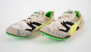 OLYMPIC MIDDLE-DISTANCE RUNNERS: Pair of Puma spiked running shoes, each with six signatures in identical positions, including those of John Landy, Roger Bannister, Sebastian Coe, Ron Clarke, and others. (2 items) - 2