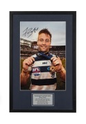 GEELONG: Signed and framed photograph of Jimmy Bartel, showing his 2011 Norm Smith Medal and Premiership Medal, accompanied by CoA; framed and glazed, overall 66 x 43cm.