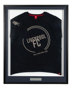 LIVERPOOL F.C.: An attractively framed and glazed guernsey, emblazoned with the club's famous phrase "You'll Never Walk Alone"; 99 x 81cm overall.