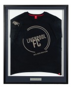 LIVERPOOL F.C.: An attractively framed and glazed guernsey, emblazoned with the club's famous phrase "You'll Never Walk Alone"; 99 x 81cm overall.