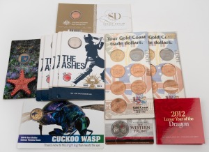 Diverse group of twelve RAM carded uncirculated issues, including 2014 Australia At War - The Western Front 50c (coloured), 2012 Lunar Year Of The Dragon 50c, 2014 Cuckoo Wasp $1 (coloured), and others.