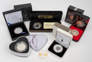 Diverse group of six silver coins/rounds, including 2002 RAM Melbourne Mint 1oz with 0.25g gold insert (x2), 2010 Great Lakes Mint Kwita Izina 1oz, and others.