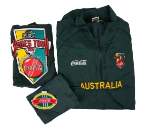 183 · ASHES TOUR 1997: Australian team-issued long-sleeve training shirt, together with raincoat, both with appropriate Coca-Cola branding.