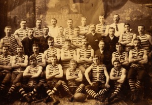 SOUTH MELBOURNE SWANS 1888/1889/1890 VFA PREMIERSHIPS: Vintage sepia-toned very large format official team photograph depicting thirty players, trainers, and officials from the period of the Swans' three consecutive Premierships, all named in manuscript in the lower margin, including Henry "Sonny" Elms (captain) and Peter Burns (vice-captain); attractively framed and glazed, 91.5 x 120cm overall, together with the original preserved backing board from Grouzelle 69 & 71 Swanston Street Melbourne.