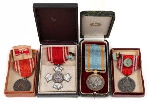 42 · JAPAN: A group of medals, in boxes of issue, comprising silver & enamel Red Cross Order of Merit, with lapel badge; Red Cross Membership medal with miniature lapel bow; Red Cross Life Membership medal with ribbon rosette and miniature lapel badge; Sea Disaster Rescue Society Merit Medal 2nd Class; (4 items).
