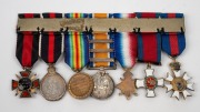 UNITED KINGDOM: A ribbon bar of seven miniature medals comprising Most Distinguished Order of St. Michael & St. George; Distinguished Service Cross; WW1 Medal - 5 clasps including Gallipoli; WW1 Victory Medal; KEVII Coronation Medal & Russian Order of Sai - 2