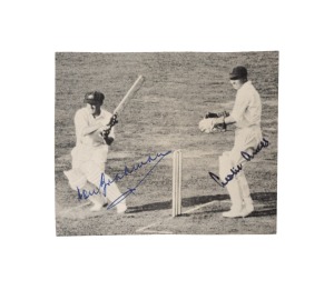 Don Bradman (batting) and Leslie Ames (wicket keeping), both signed in ink to a small magazine picture depicting Bradman's follow-through as Ames watches the ball run to the boundary.